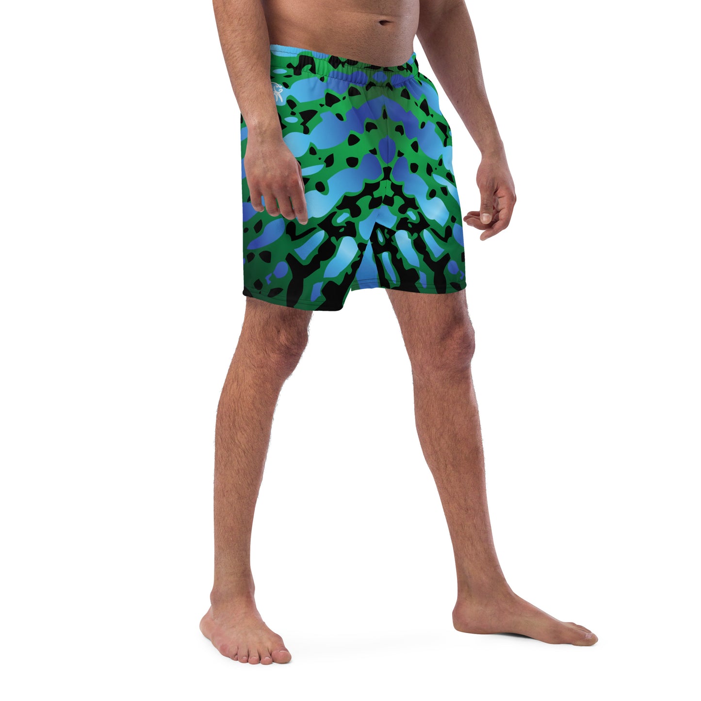 Man modeling the Betta Muay Swim trunks from the front-side in Blues, Greens, and Black.