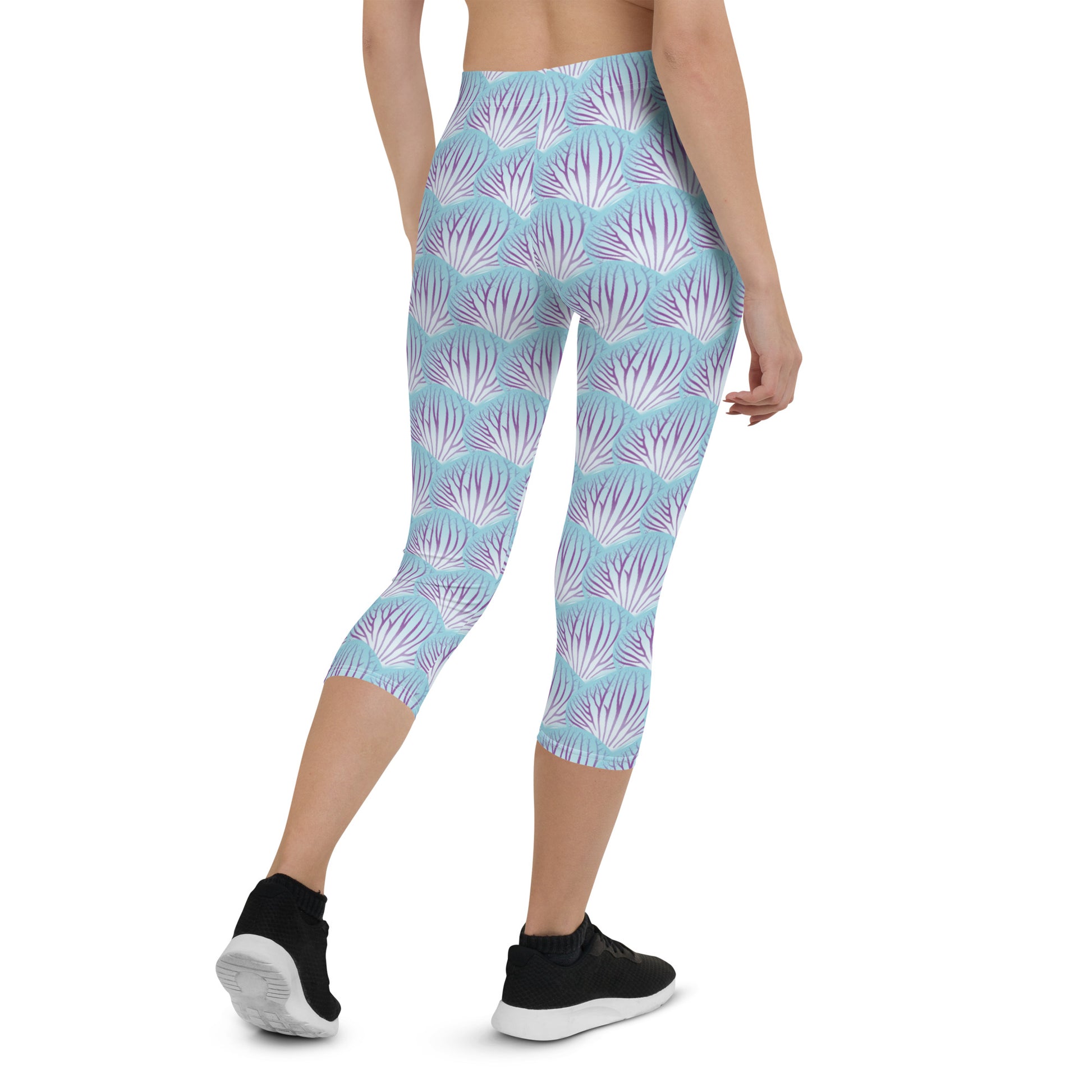 Woman modeling the Orchid Petal printed apri leggings from the rear in a weight-shift stance.