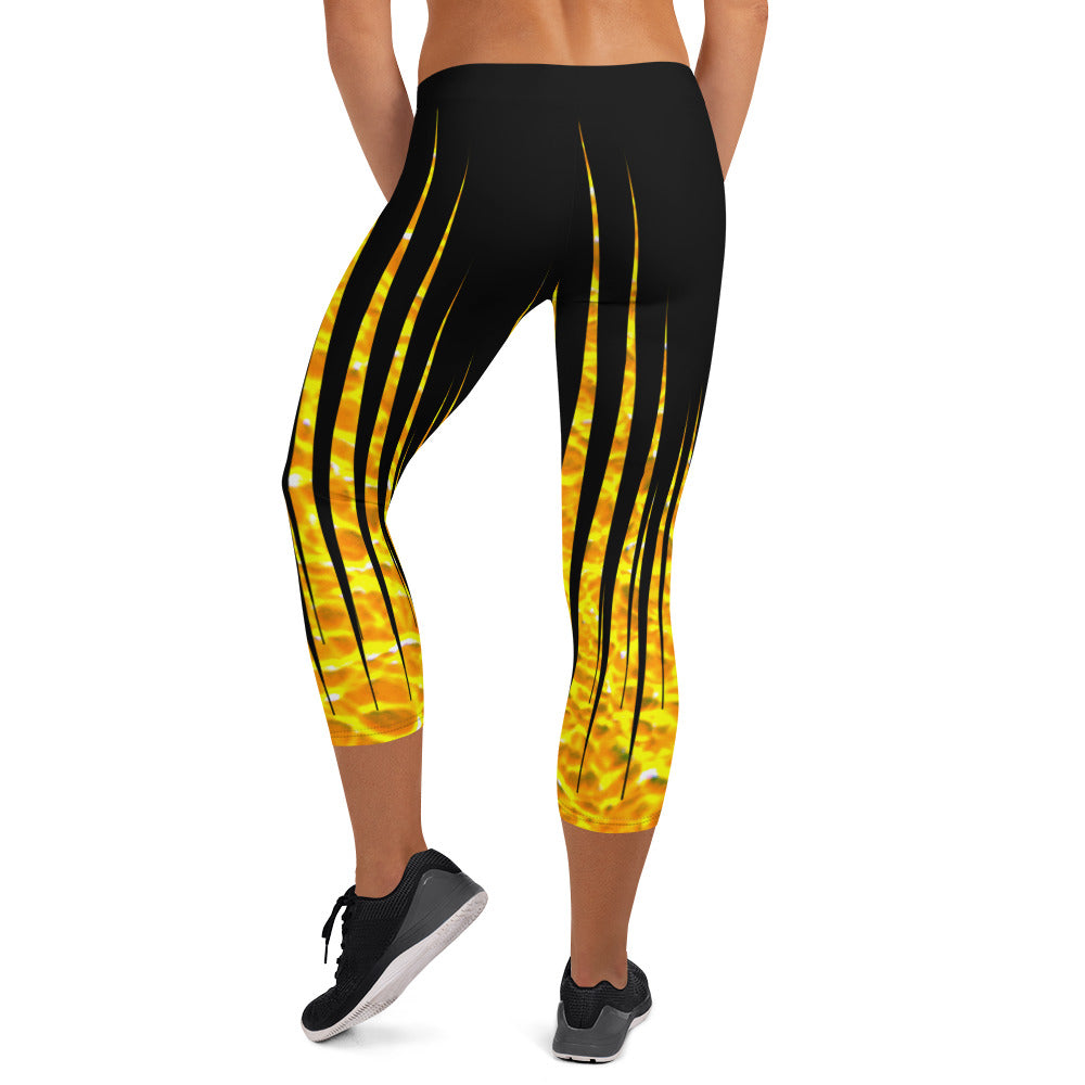 Woman modeling the Black and Fire printed Fired Up Capri leggings from the back.