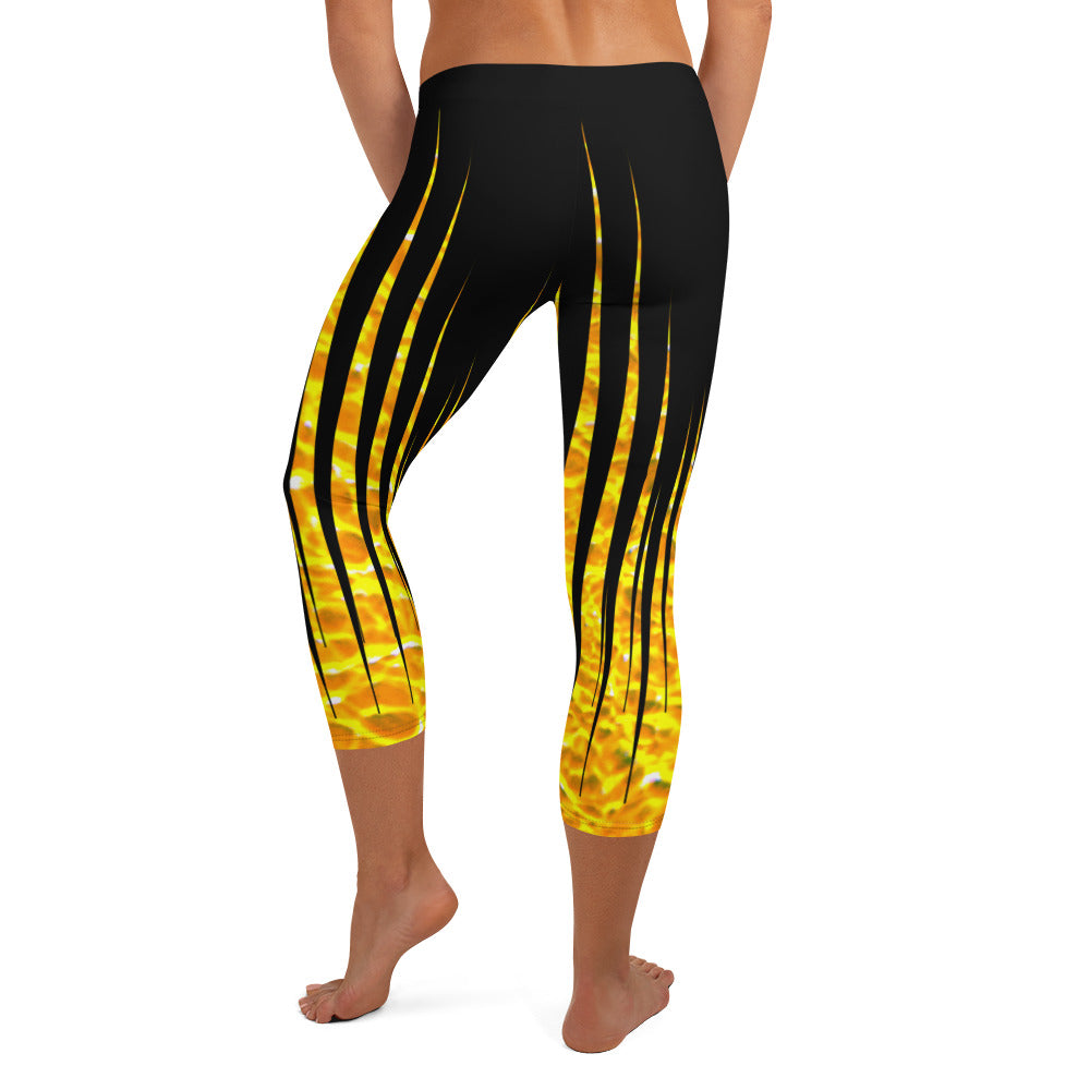 Woman modeling the Black and Fire printed Fired Up Capri leggings from the back.