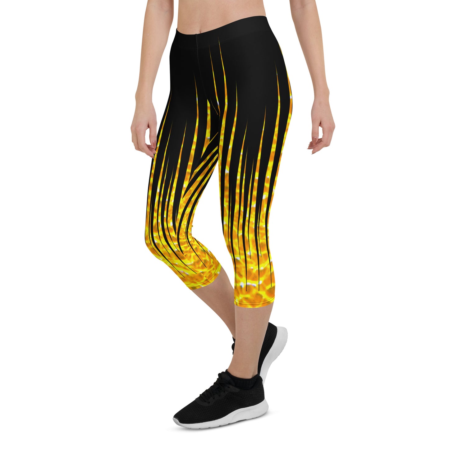 Woman modeling the Black and Fire printed Fired Up Capri leggings from the right front.