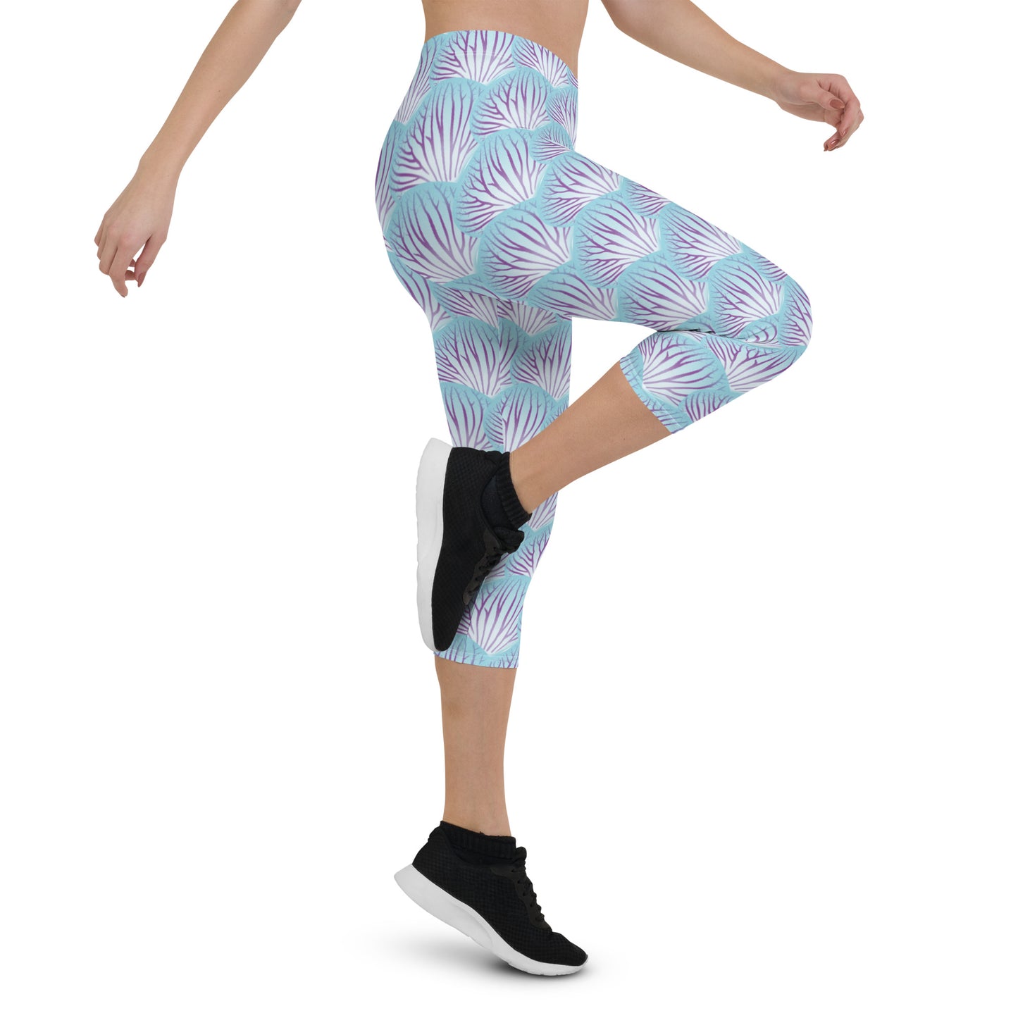 Woman modeling the Orchid Petal printed apri leggings high-stepping from the side.