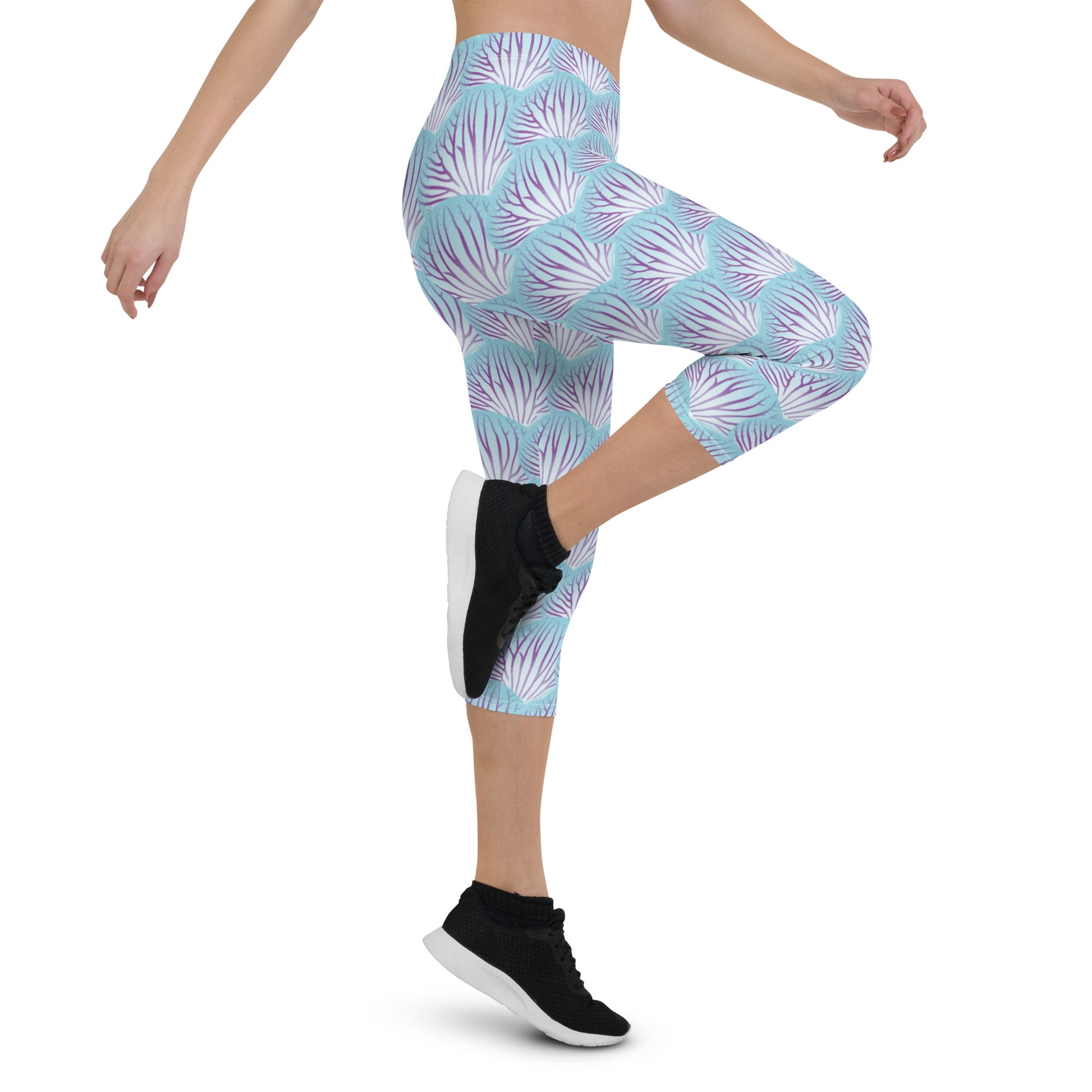 Woman modeling the Orchid Petal printed apri leggings high-stepping from the side.