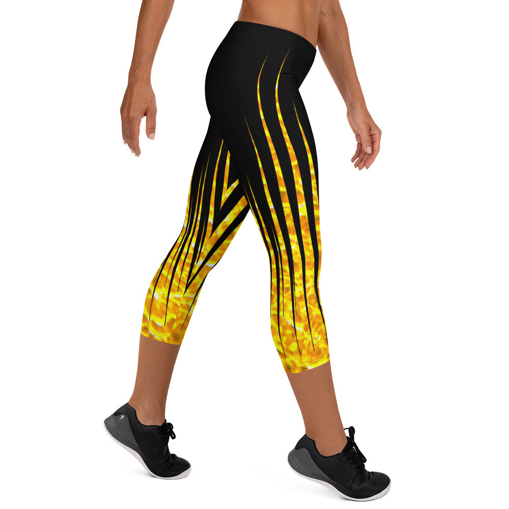 Woman modeling the Black and Fire printed Fired Up Capri leggings from the side.