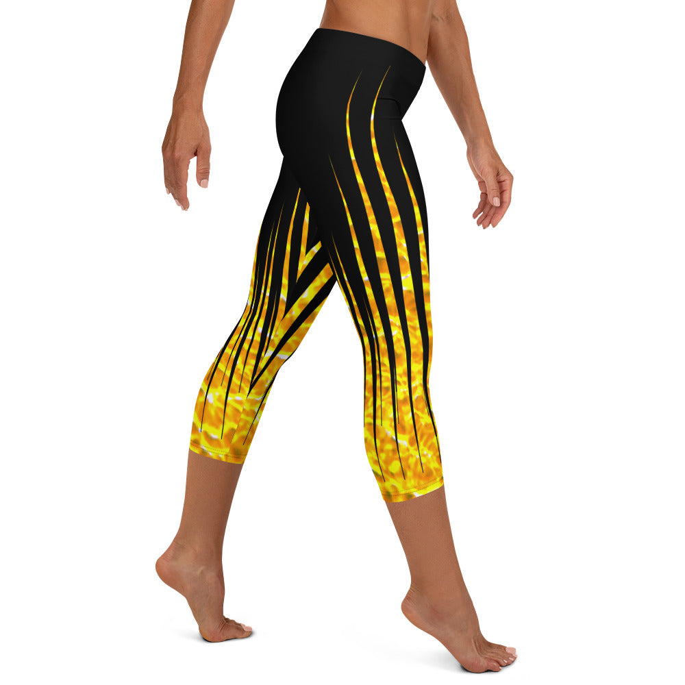 Woman modeling the Black and Fire printed Fired Up Capri leggings from the side.