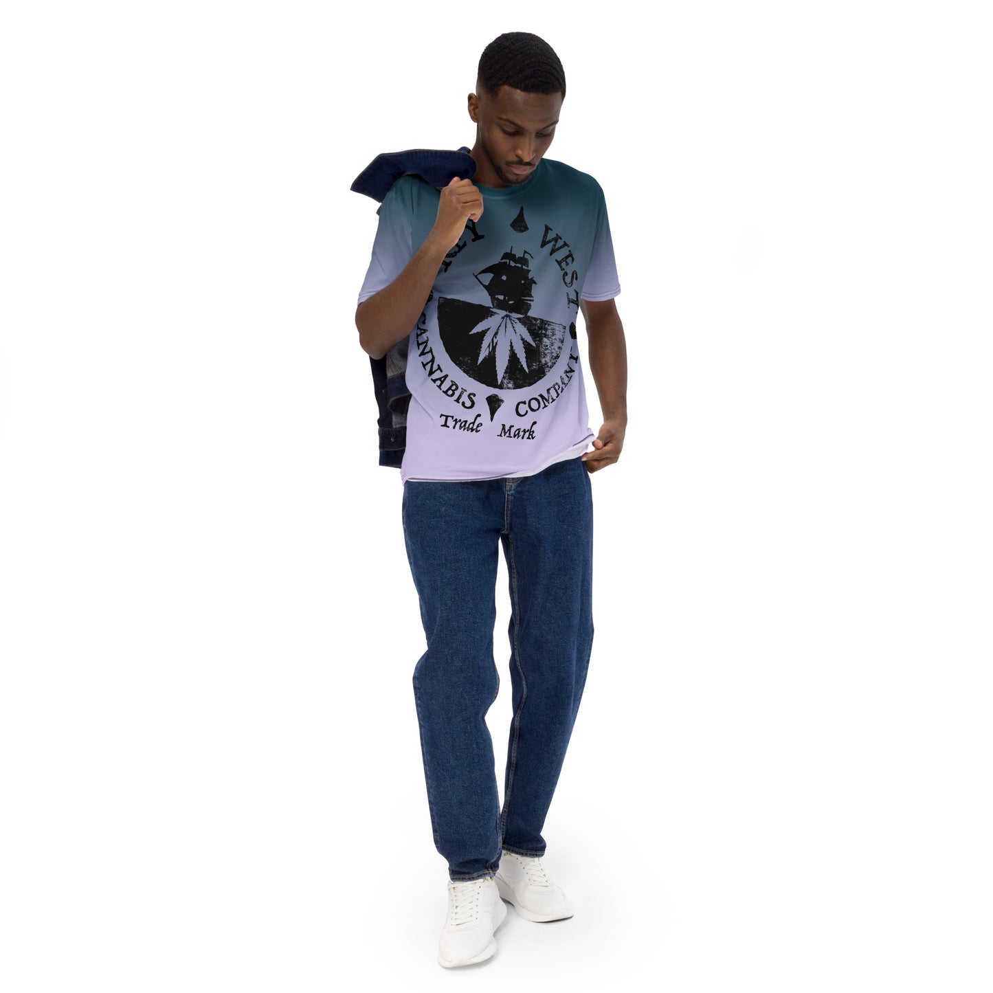 Man modeling the Key West Cannabis Company Brand T-shirt with oversize print on a gradient background from the front with a jacket over his sholder.