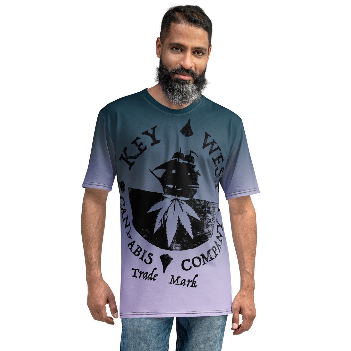 Bearded man modeling the Key West Cannabis Company Brand T-shirt with oversize print on a gradient background from the front.
