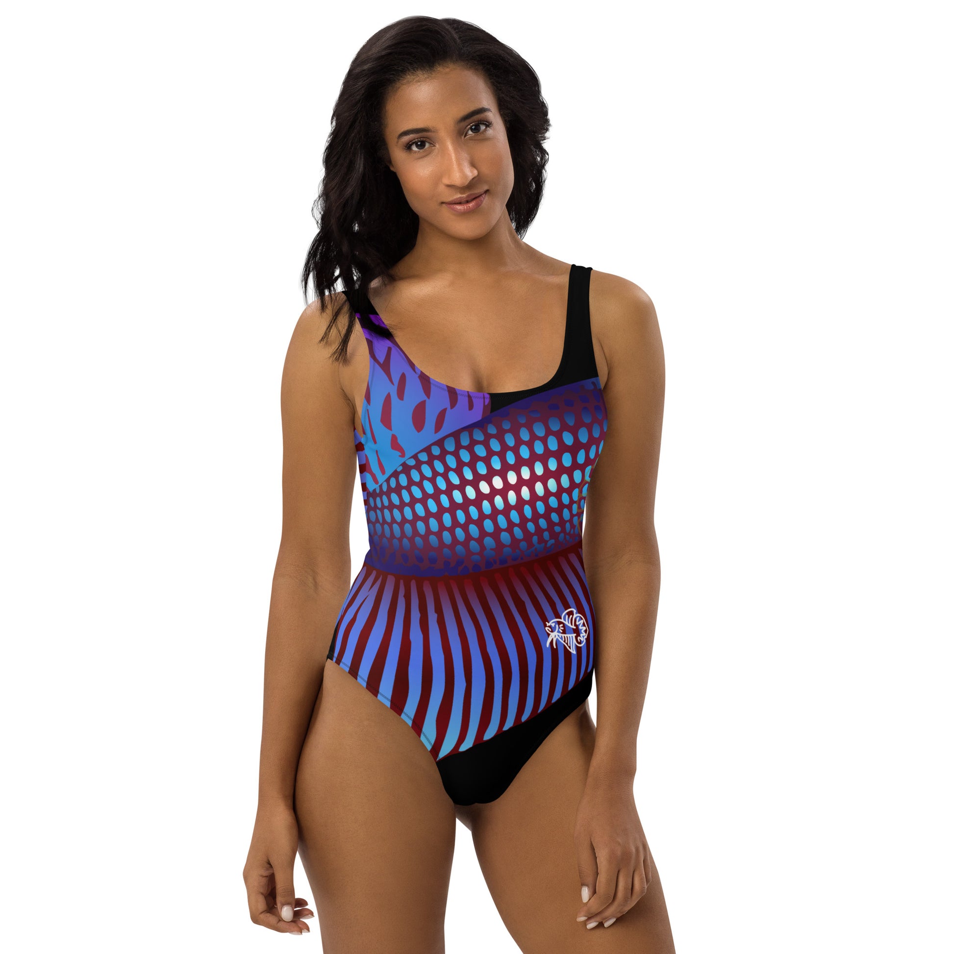 Woman modeling the Betta Ka One Piece Swimsuit in purples, reds, and blue patterns from the front.