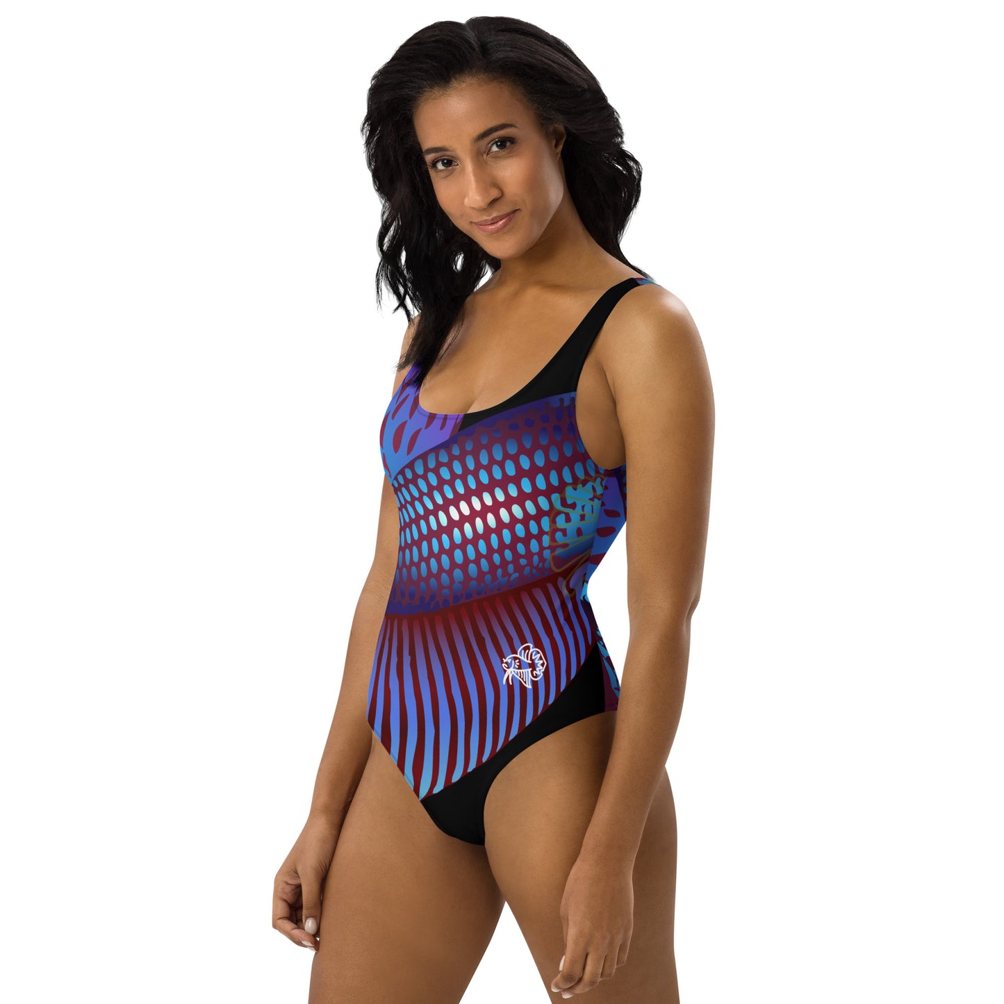 Woman Wearing the Betta Ka one-piece swimsuit in purples, reds, and blue patterns from the left front.