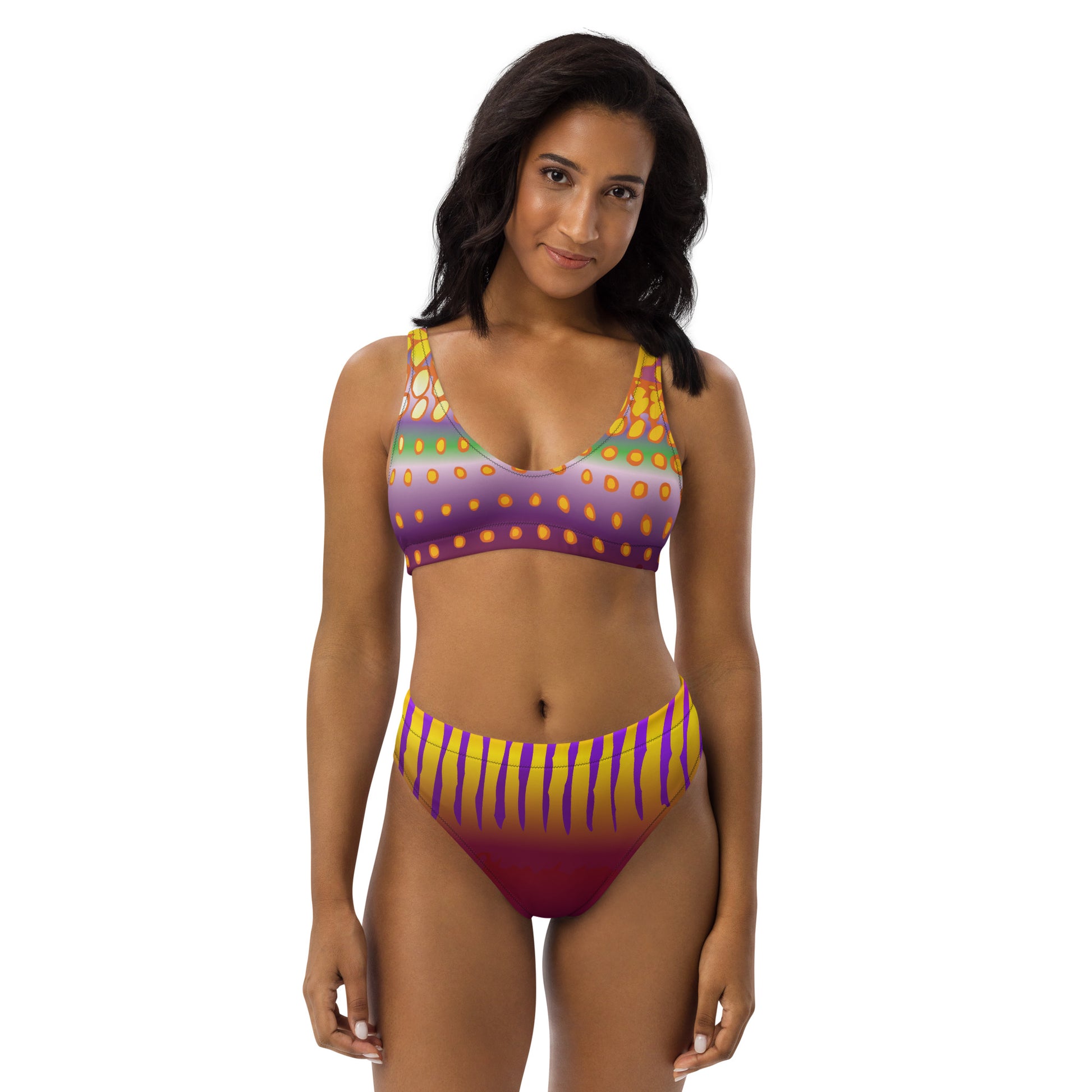 Woman Modeling the Betta Sawng Bikini Swimsuit in purples, oranges, yellows, and green patterns from the front.