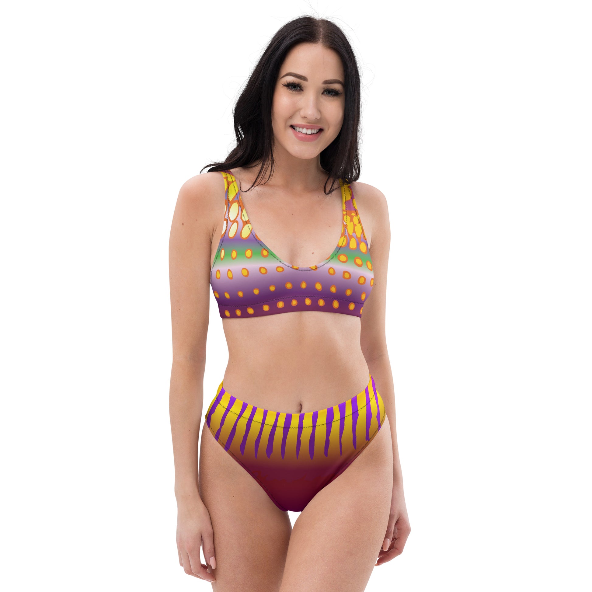Woman Modeling the Betta Sawng Bikini Swimsuit in purples, oranges, yellows, and green patterns from the front.