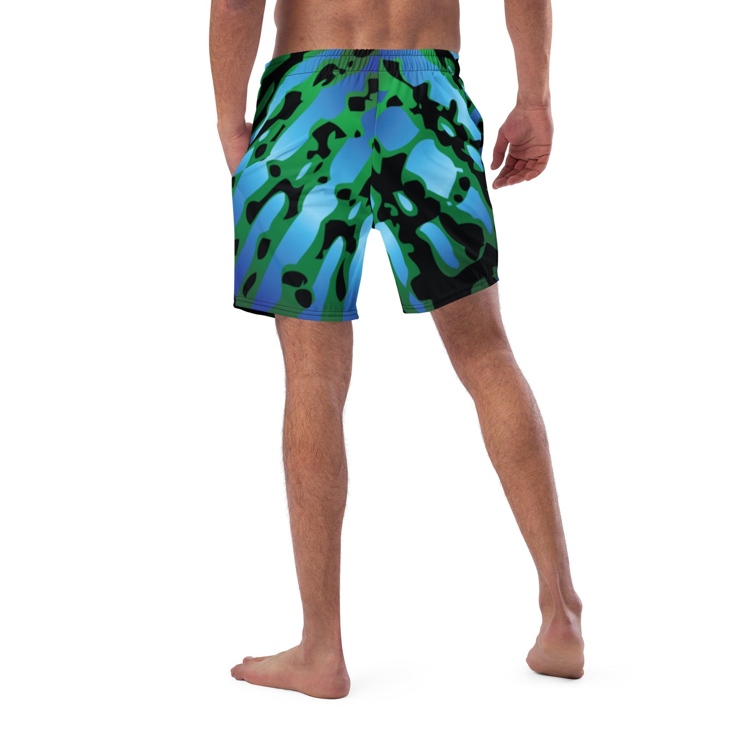 Man modeling the Betta Muay Swim trunks from the back in Blues, Greens, and black.