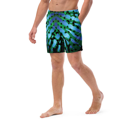 Close up of Man modeling the Betta Muay Swim trunks from the front-right in Blues, Greens, and Black.