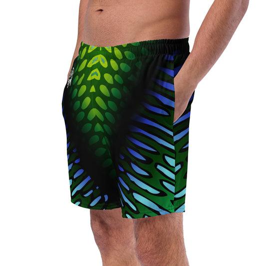 Male model Wearing the Betta Yak mens swim trunks in blue and green from the side.