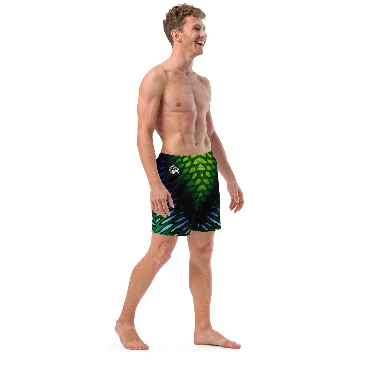 Male model wearing the Betta Yak Mens swim trunks in blue and green from the right side.