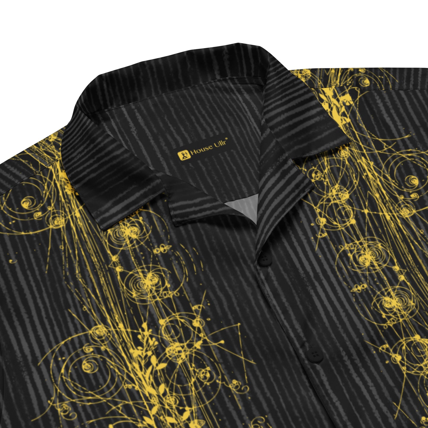 Close up of the Anura Theta Button Shirt showing the gold  particle energy design. and collar detail.