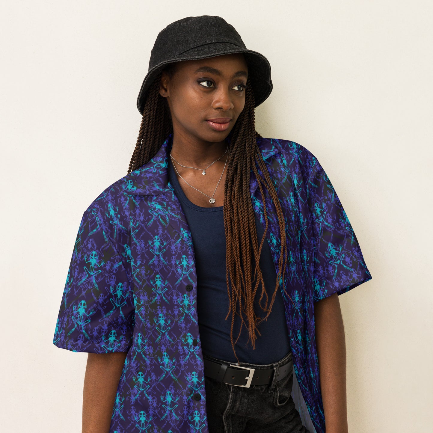 Close up of female model wearing the Anura Zeta Button down shirt with purple black and turquoise frog bones.