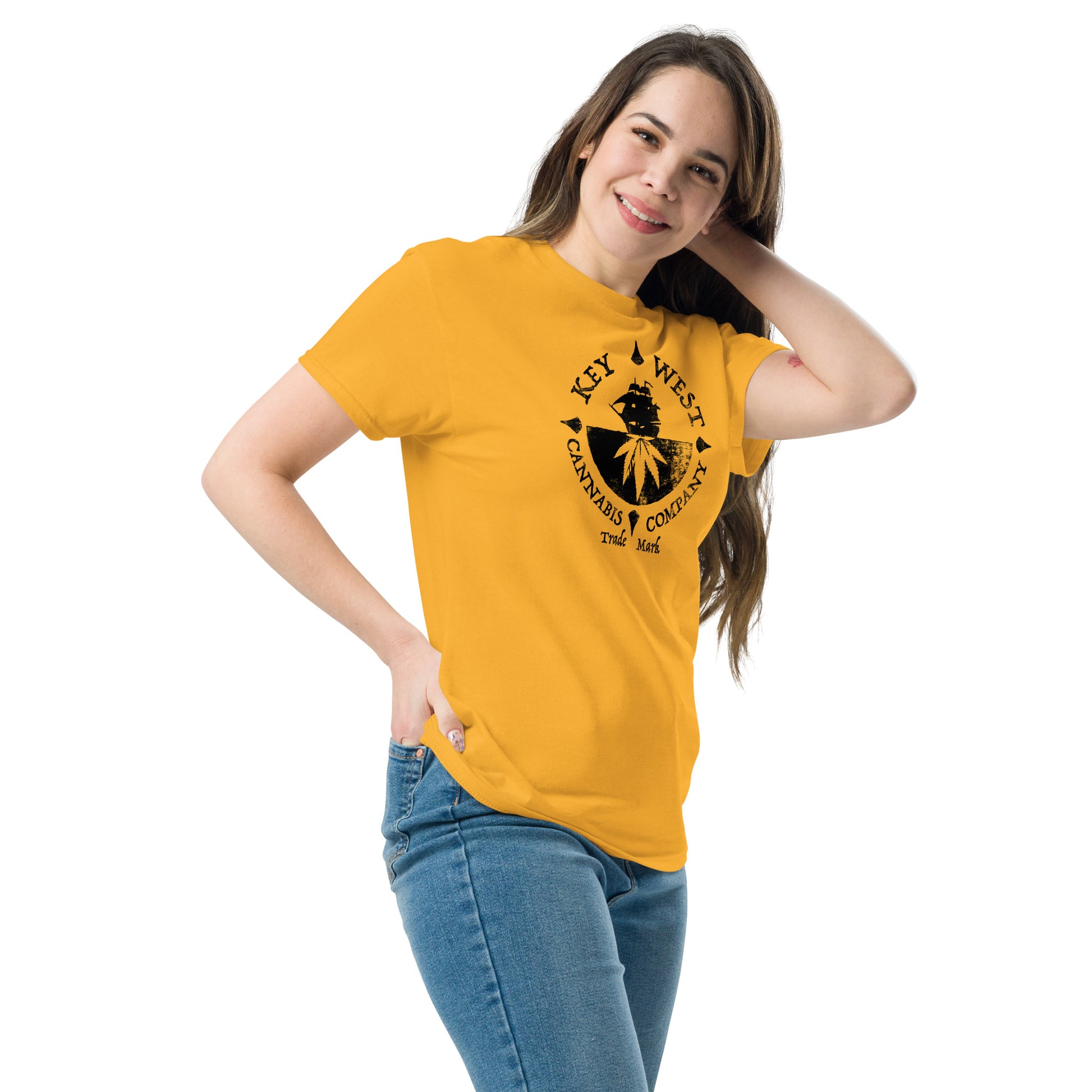 Woman modeling the Key West Cannabis Company Brand graphic in black on a Gold Color T-shirt from the right front.
