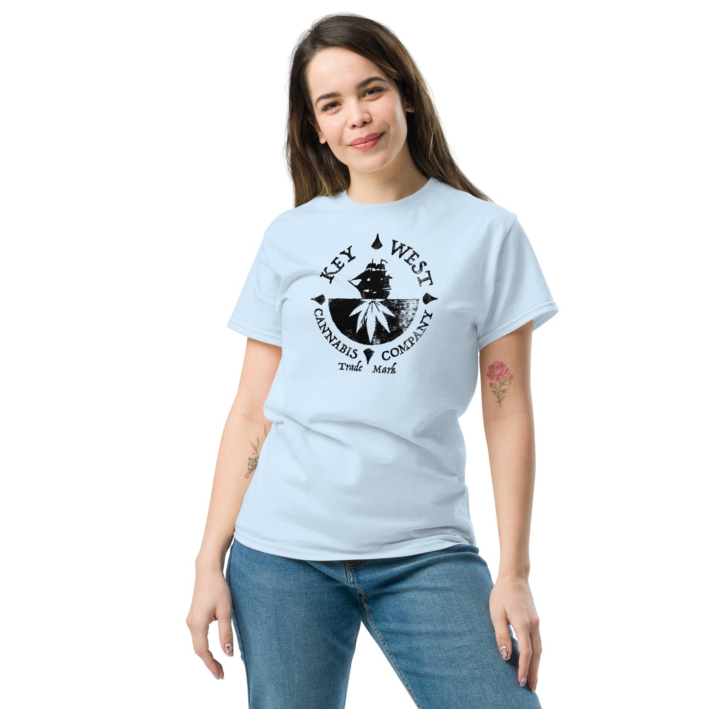 Woman modeling the Key West Cannabis Company Brand graphic in black on a light blue T-shirt from the front.