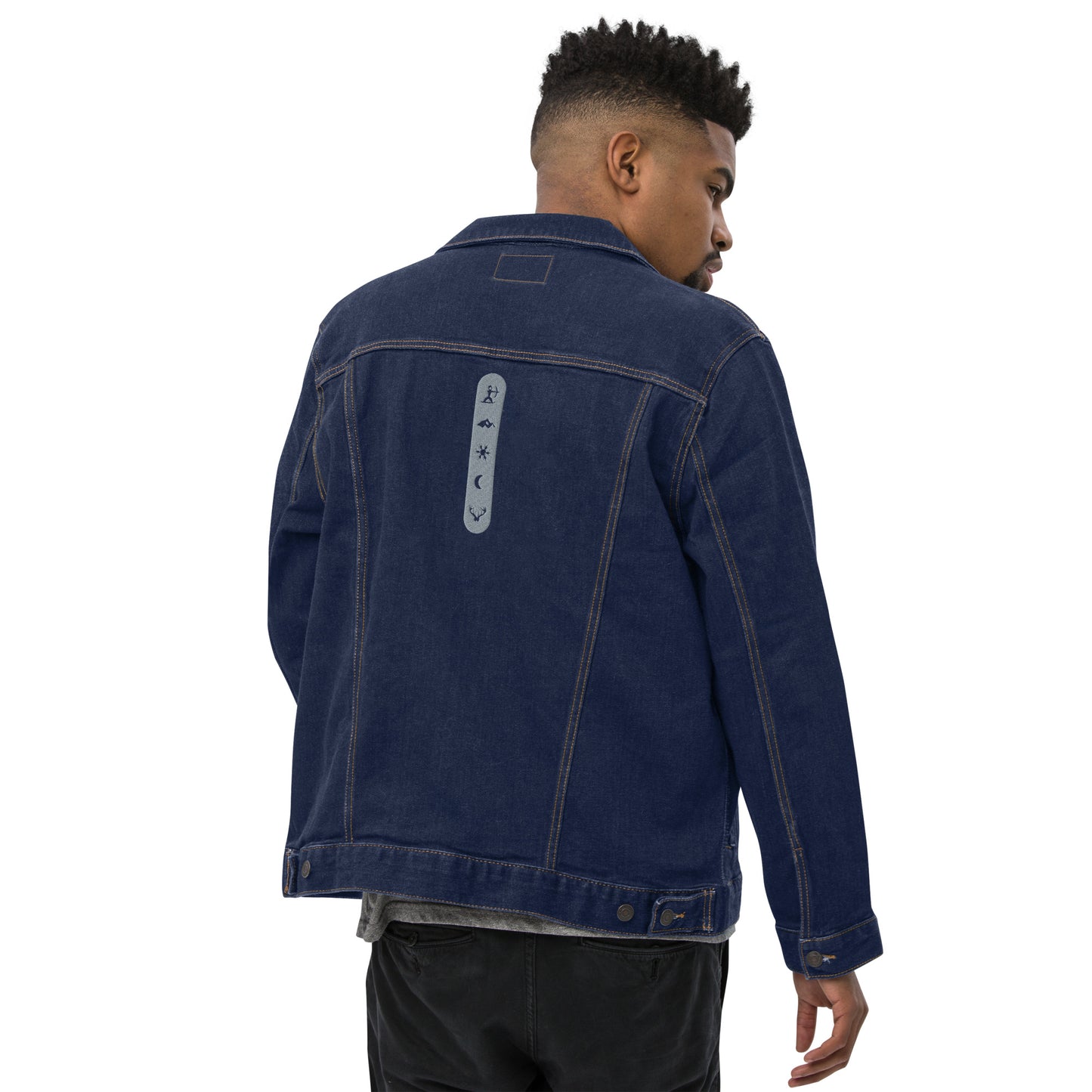 Male model wearing House Ullr Unisex Denim Jacket from the back in Blue Denim showing House Story embroidery.