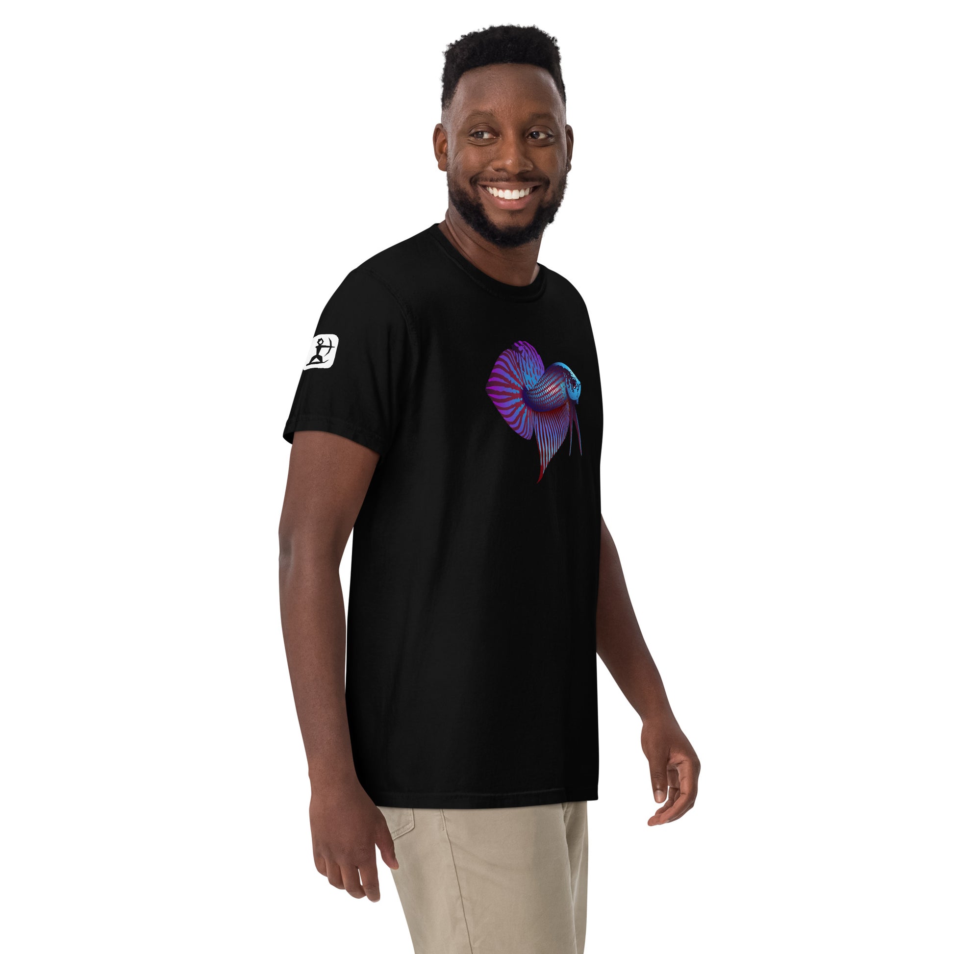 Male Model wearing the Betta Si fighting fish T-Shirt in Blues, reds, and purples from the side showing the House Ullr Icon.