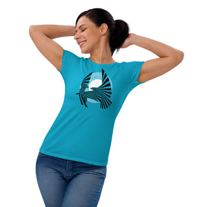 Woman wearing the Birds of Peace t-shirt on a Caribbean Blue shirt, from the front, with arms behind her head.